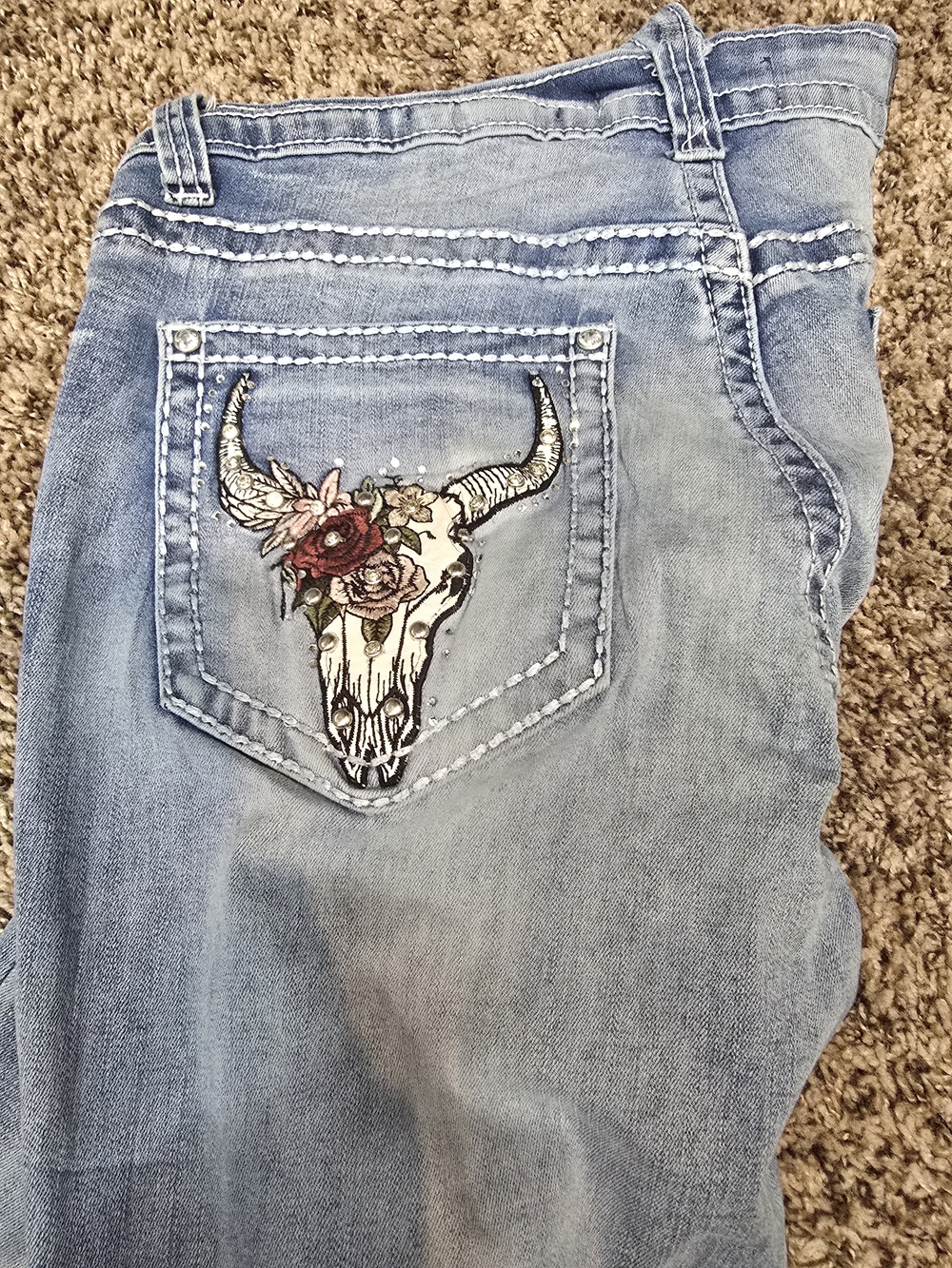 Light Blue Bootcut Jeans with Embroidered Skull Pocket